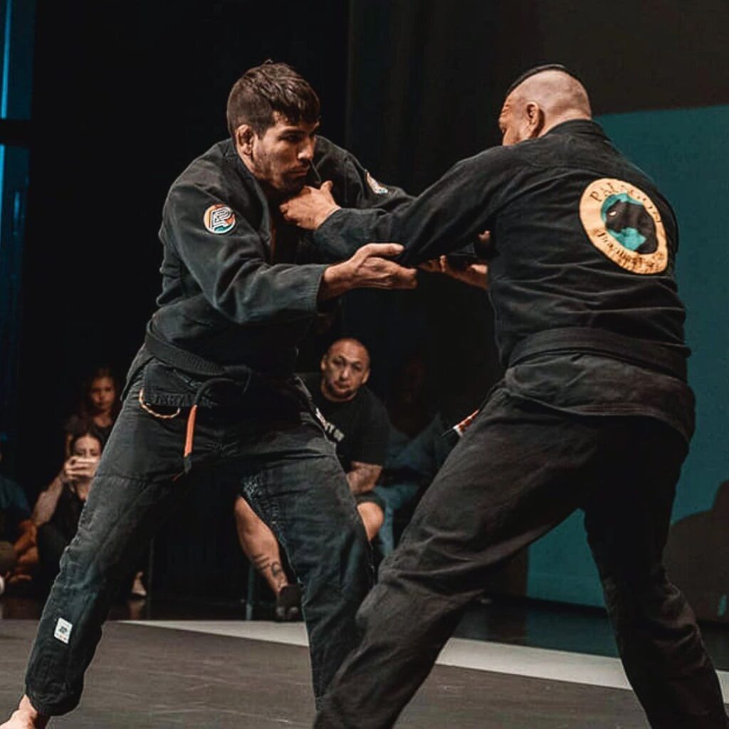 Black belt grip fighting in a black gi