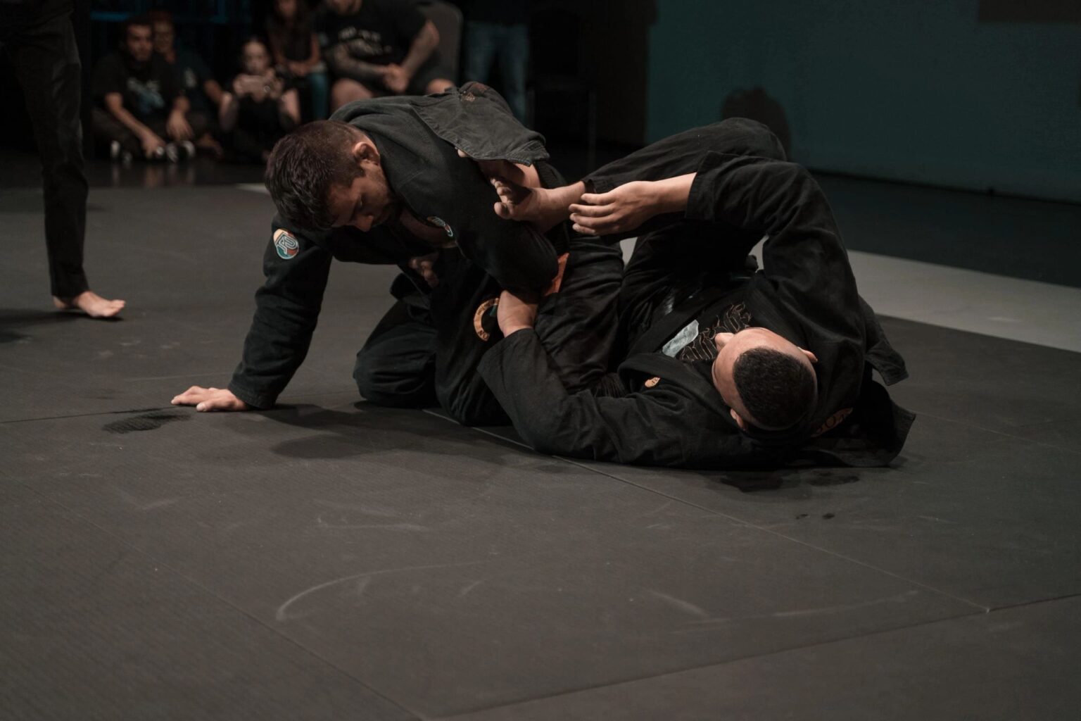 Two athletes in black gis drilling a guard pass at 12th Street Jiu Jitsu