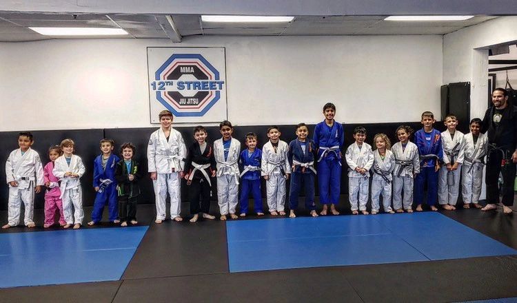 Kids Brazilian Jiu Jitsu class lined up on the mats